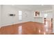 Living room with hardwood floors and kitchen access at 1304 Queen Lyon Ct, Charlotte, NC 28205