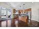 Modern kitchen with stainless steel appliances, an island, and hardwood floors at 13146 Heath Grove Dr, Huntersville, NC 28078