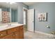 Bathroom with wooden vanity, shower, and neutral tile floor at 13836 Ballantyne Meadows Dr, Charlotte, NC 28277