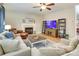 Bright living room with fireplace and large TV at 13836 Ballantyne Meadows Dr, Charlotte, NC 28277