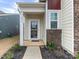 Front entrance with a glass storm door, brick and siding exterior, and landscaping at 1417 Turkey Roost Rd # 69, Fort Mill, SC 29715