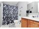 Bathroom with shower/tub combo, wood vanity, and tropical shower curtain at 15210 Pangborn Pl, Charlotte, NC 28278