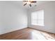 Bright bedroom features hardwood floors, window, ceiling fan, and white walls at 15927 Vale Ridge Dr, Charlotte, NC 28278