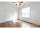 Comfortable bedroom featuring hardwood floors, bright window, ceiling fan, and closet at 15927 Vale Ridge Dr, Charlotte, NC 28278