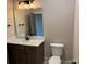 Bathroom with toilet and vanity, granite countertops and dark fixtures at 18140 Kalabash Rd, Charlotte, NC 28278