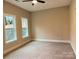 Spacious carpeted bedroom with two windows that allow natural light to enter at 18140 Kalabash Rd, Charlotte, NC 28278