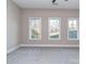 Bright living room with plush carpet and large windows with backyard views at 18140 Kalabash Rd, Charlotte, NC 28278