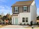 Two-story townhome with gray siding, light-colored trim, and a teal front door at 205 Cliffwood Nw St # B-2, Concord, NC 28027