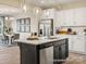 Modern kitchen with an island, stainless steel appliances, and white shaker cabinets at 205 Cliffwood Nw St # B-2, Concord, NC 28027