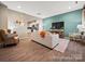 Open living space with a comfortable sofa and access to the kitchen at 205 Cliffwood Nw St # B-2, Concord, NC 28027