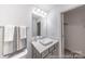 Clean bathroom featuring a modern vanity with solid surface countertop and decorative mirror at 205 Cliffwood Nw St # B-2, Concord, NC 28027