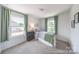 Well lit bedroom showcasing carpet floors, two windows, and neutral colored walls at 205 Cliffwood Nw St # B-2, Concord, NC 28027