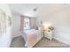 Cozy bedroom with a plush bed, complementary decor and a sunlit window at 205 Cliffwood Nw St # B-2, Concord, NC 28027