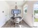 Bright breakfast nook with modern light fixture and table, plus door to the outside at 205 Cliffwood Nw St # B-2, Concord, NC 28027
