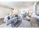 Open-concept living room with hardwood floors, a cozy sofa, and a view of the kitchen at 205 Cliffwood Nw St # B-2, Concord, NC 28027