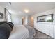 Main bedroom featuring a bed with gray pillows, white dresser, and ensuite bathroom at 205 Cliffwood Nw St # B-2, Concord, NC 28027