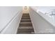Carpeted staircase with white walls and railing leading to the upper level at 205 Cliffwood Nw St # B-2, Concord, NC 28027