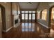 Spacious living room with hardwood floors, fireplace, and large windows at 2321 Herrons Nest Nw Pl, Concord, NC 28027