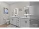 Modern bathroom with double vanity and lighted mirrors at 3630 N Davidson St # 2210, Charlotte, NC 28205