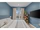 Bright bedroom with a large bed, window, and built-in shelving at 3630 N Davidson St # 2210, Charlotte, NC 28205