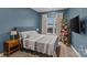 Cozy bedroom featuring a striped comforter and wooden nightstand at 3630 N Davidson St # 2210, Charlotte, NC 28205