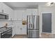 White kitchen with stainless steel appliances and subway tile backsplash at 3630 N Davidson St # 2210, Charlotte, NC 28205