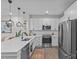 Modern kitchen with white cabinets, stainless steel appliances, and a breakfast bar at 3630 N Davidson St # 2210, Charlotte, NC 28205