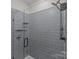 Large walk-in shower with gray tile and glass enclosure at 3630 N Davidson St # 2210, Charlotte, NC 28205