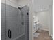 Walk-in shower with gray tile and glass enclosure at 3630 N Davidson St # 2210, Charlotte, NC 28205
