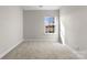 Cozy bedroom with a window and neutral wall colors at 3698 Aldeburgh Sw Rd, Concord, NC 28027