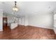 Open dining room with hardwood floors and kitchen views at 3698 Aldeburgh Sw Rd, Concord, NC 28027