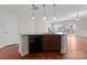 Modern kitchen island with granite countertop and black appliances at 3698 Aldeburgh Sw Rd, Concord, NC 28027