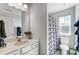 Clean bathroom featuring a single vanity, framed mirror, and shower with a decorative curtain at 4512 Iron Oak Ln, Charlotte, NC 28269