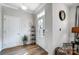 Bright entryway with wood floors, white door, and small shelf at 4512 Iron Oak Ln, Charlotte, NC 28269