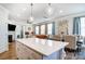 Open-concept kitchen with a quartz island overlooking the living room at 4512 Iron Oak Ln, Charlotte, NC 28269