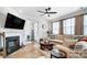 Open living room with sectional sofa, fireplace, and hardwood floors at 4512 Iron Oak Ln, Charlotte, NC 28269