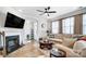 Cozy living room with a fireplace, wooden floors, and neutral-toned furniture at 4512 Iron Oak Ln, Charlotte, NC 28269