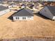 Aerial view of a single-story house with backyard and surrounding homes at 6420 Barcelona Way, Charlotte, NC 28214