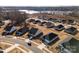Community overview showcasing numerous houses near a lake at 6420 Barcelona Way, Charlotte, NC 28214