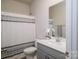 Clean bathroom with a single vanity, toilet, and shower/tub combo at 6420 Barcelona Way, Charlotte, NC 28214