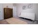 Spacious bedroom with a queen bed, a sofa, and wood dresser at 6420 Barcelona Way, Charlotte, NC 28214