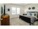 Spacious bedroom with a large bed, dresser, and neutral color palette at 6420 Barcelona Way, Charlotte, NC 28214