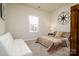 Cozy bedroom with a queen bed, a sofa, and a compass wall decoration at 6420 Barcelona Way, Charlotte, NC 28214