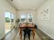 Bright dining room featuring a wood table, sliding glass doors, and hardwood floors at 6420 Barcelona Way, Charlotte, NC 28214