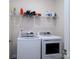 Convenient laundry room with washer, dryer, and overhead shelving at 6420 Barcelona Way, Charlotte, NC 28214