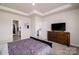 Main bedroom with a dresser, large TV, and view of the bathroom and kitchen at 6420 Barcelona Way, Charlotte, NC 28214