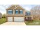 Two-story house with stone accents and a two-car garage at 8012 Kennesaw Dr, Gastonia, NC 28056