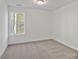 Simple bedroom with neutral walls and carpet at 815 Sherwood Ave, Albemarle, NC 28001