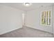 Bright bedroom with grey carpet and a view of the woods at 815 Sherwood Ave, Albemarle, NC 28001