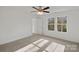 Bright bedroom with large windows and ceiling fan at 815 Sherwood Ave, Albemarle, NC 28001